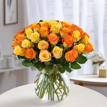 24 Yellow and Orange Roses in a Glass Vase